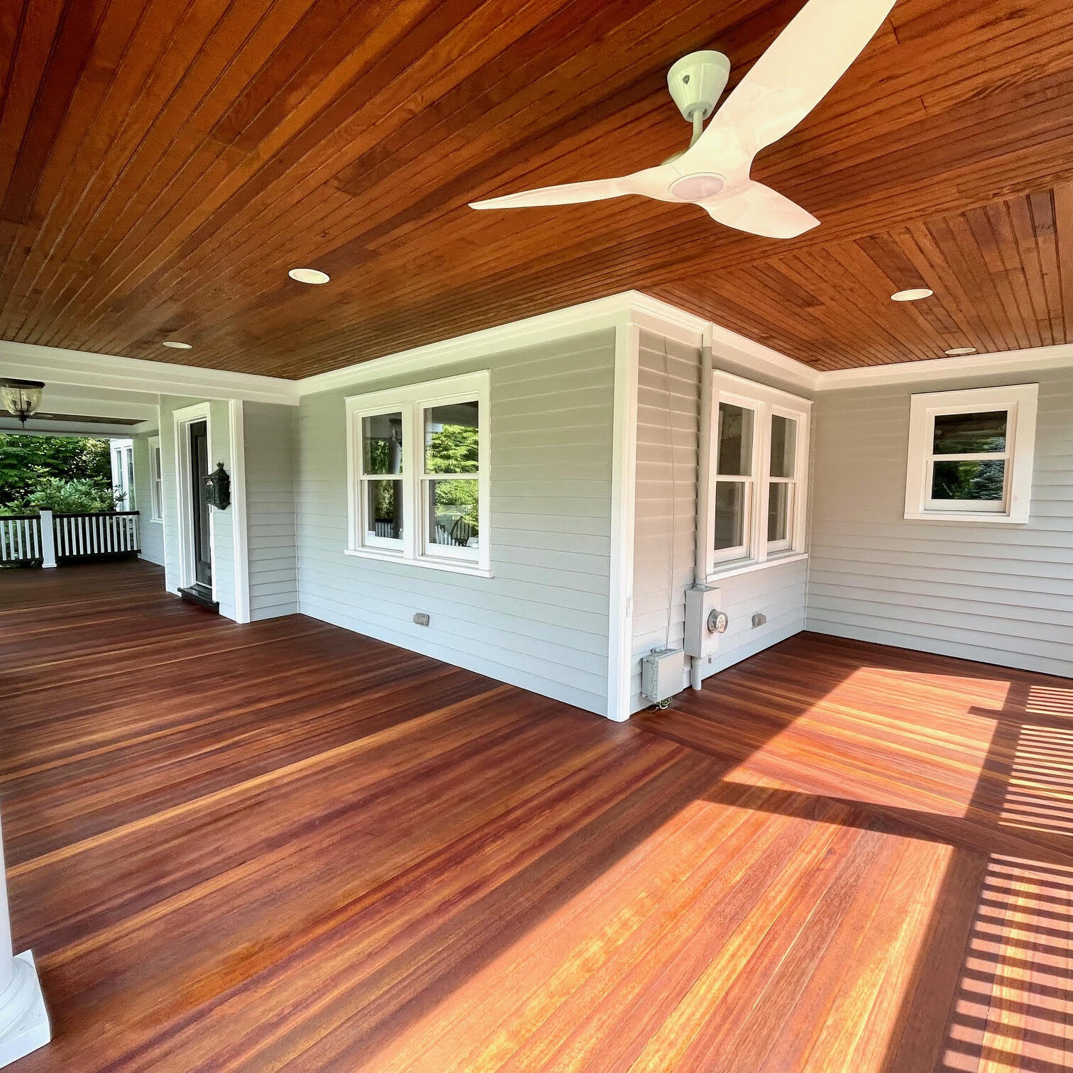 Covered porch with wooden floor and fan